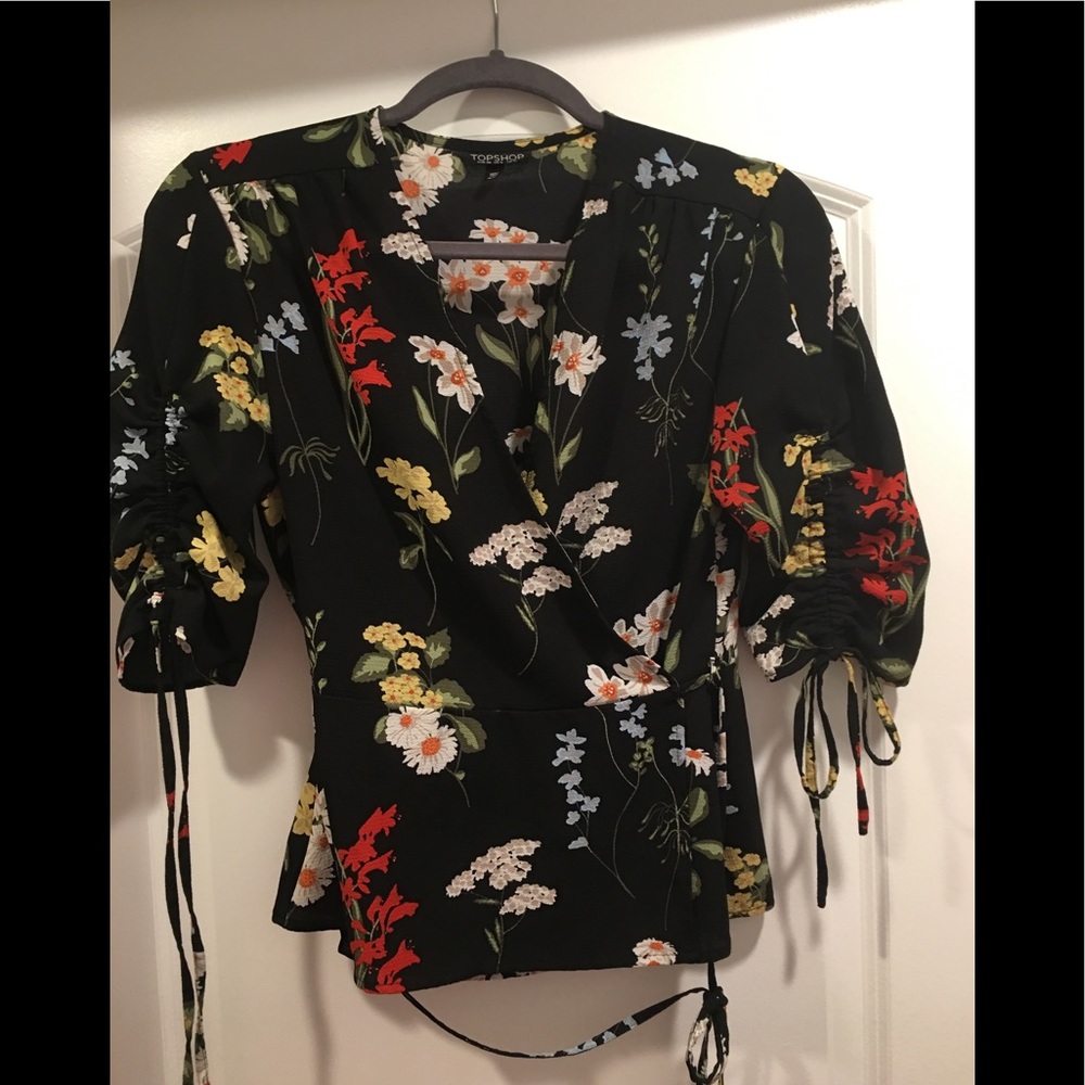 Floral print peplum wrap top with ruched sleeves
